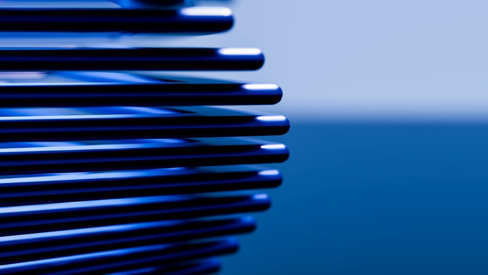 Stack of smooth rounded blue metallic objects with reflections