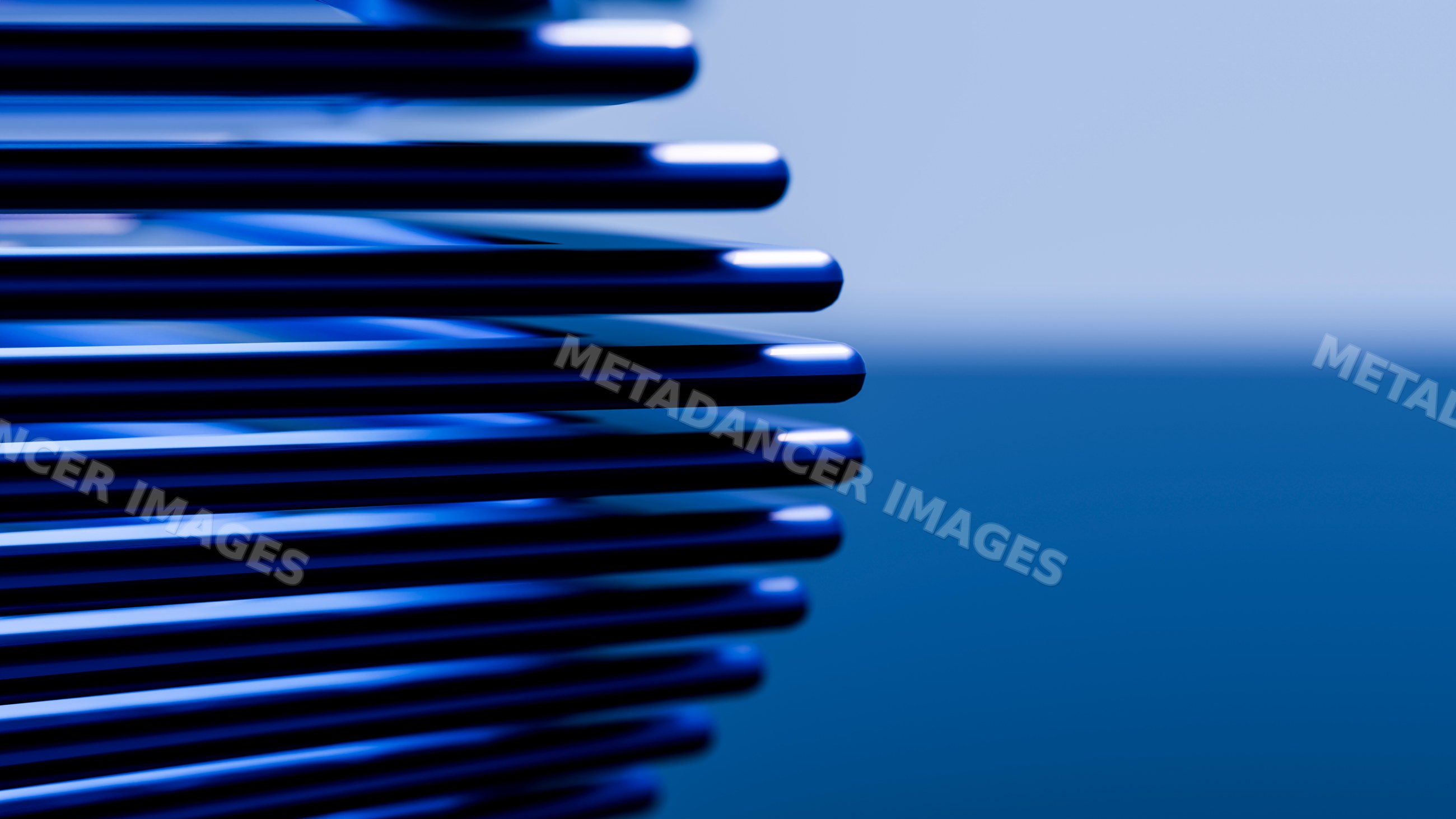 Stack of smooth rounded blue metallic objects with reflections