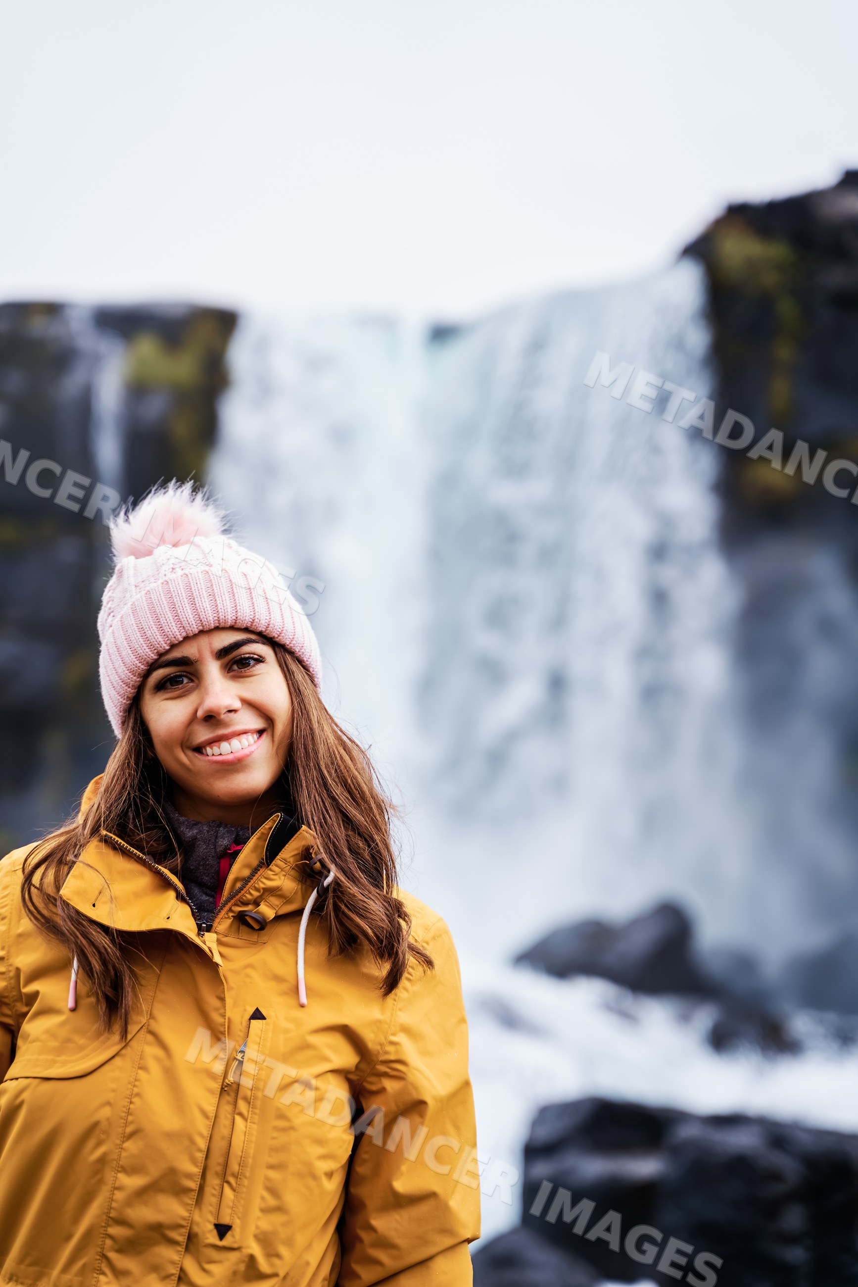 A young white woman wearing winter clothes smiles