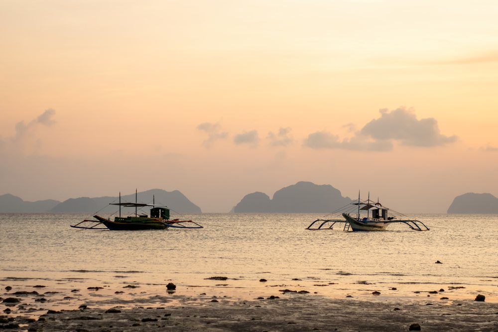 Two boats float on calm sea