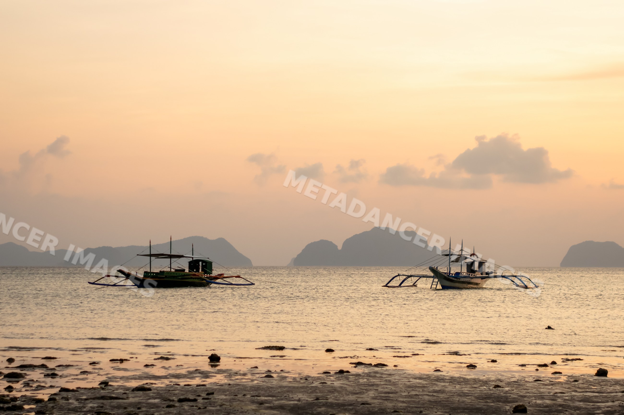 Two boats float on calm sea
