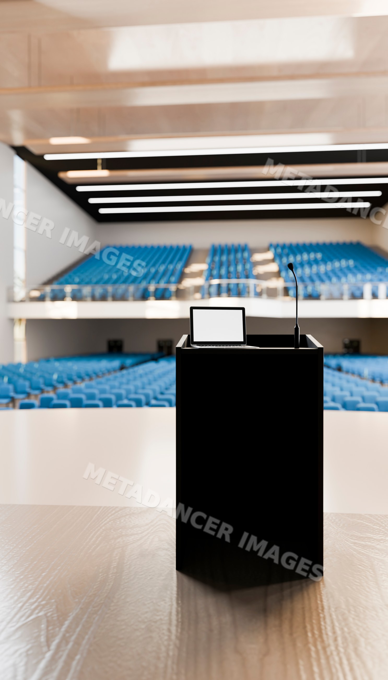 Podium with laptop and microphone in empty modern lecture hall