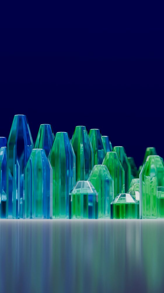 Cluster of colorful blue and green glass crystals on reflective