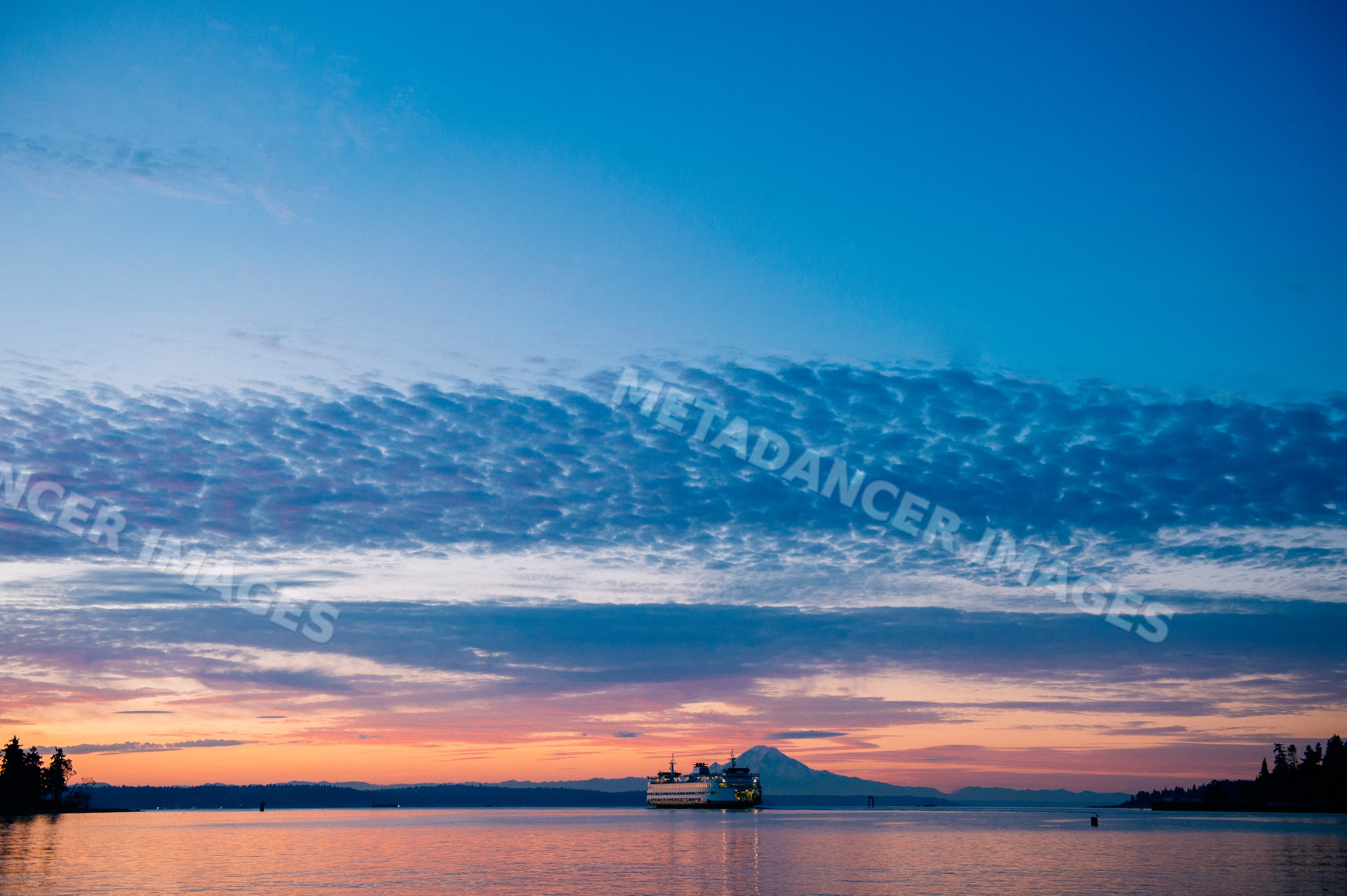 Ferry crossing water near mount rainier at sunset on Bainbridge Island