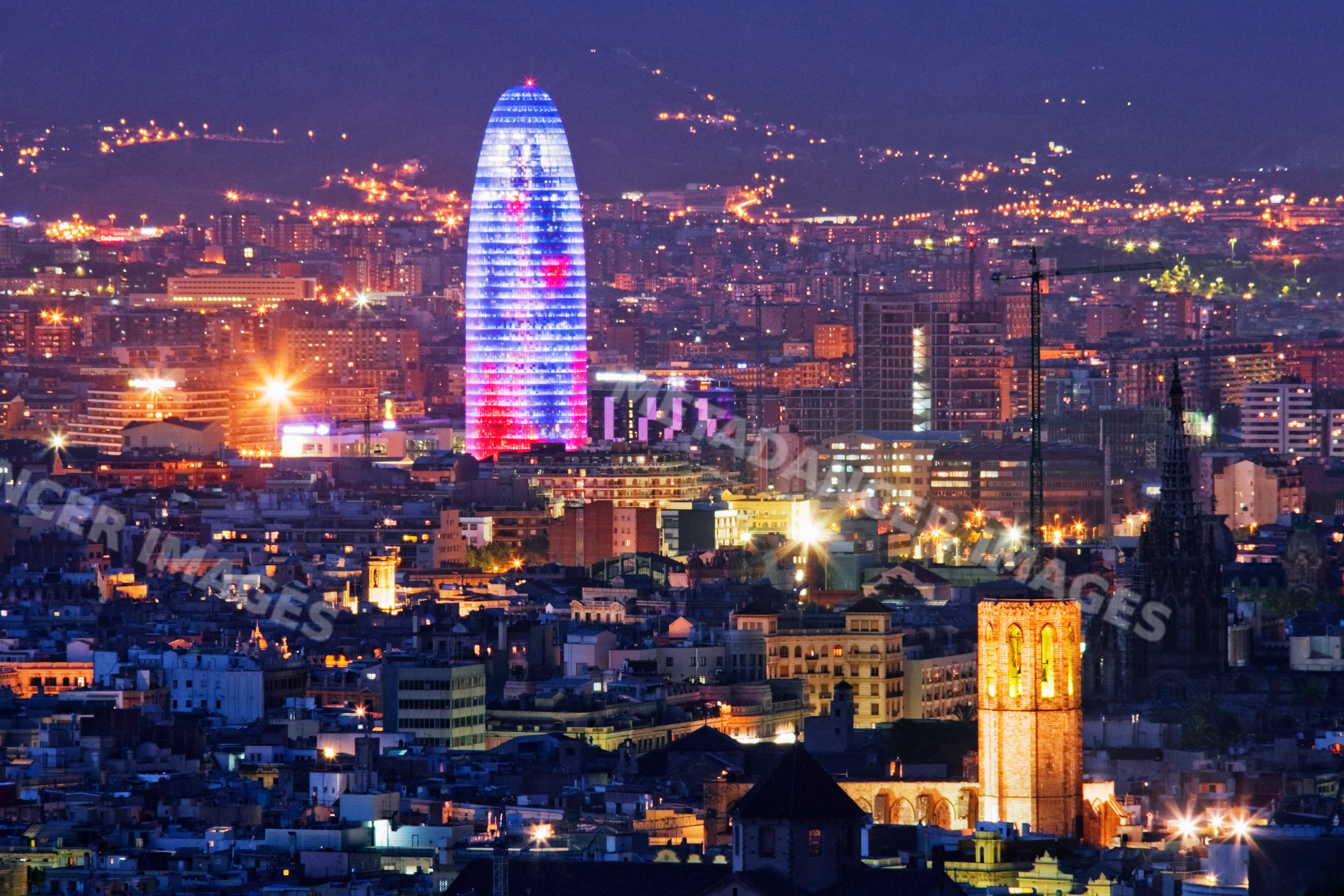 Barcelona cityscape at night featuring illuminated torre glòries