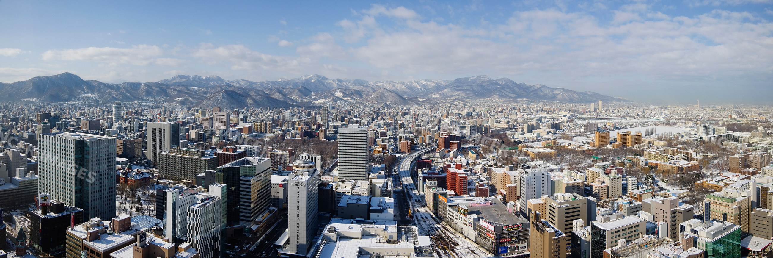 City skyline with snowy buildings and mountains, hokkaido, japan
