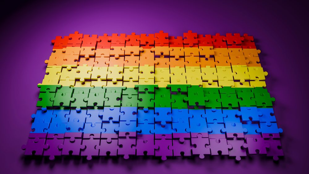 Jigsaw puzzle with rainbow color gradient partially assembled