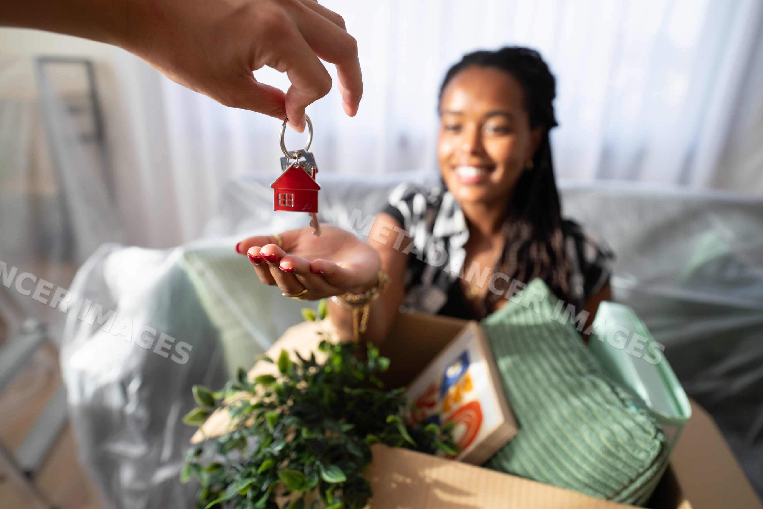 A African American woman happily receives house keys
