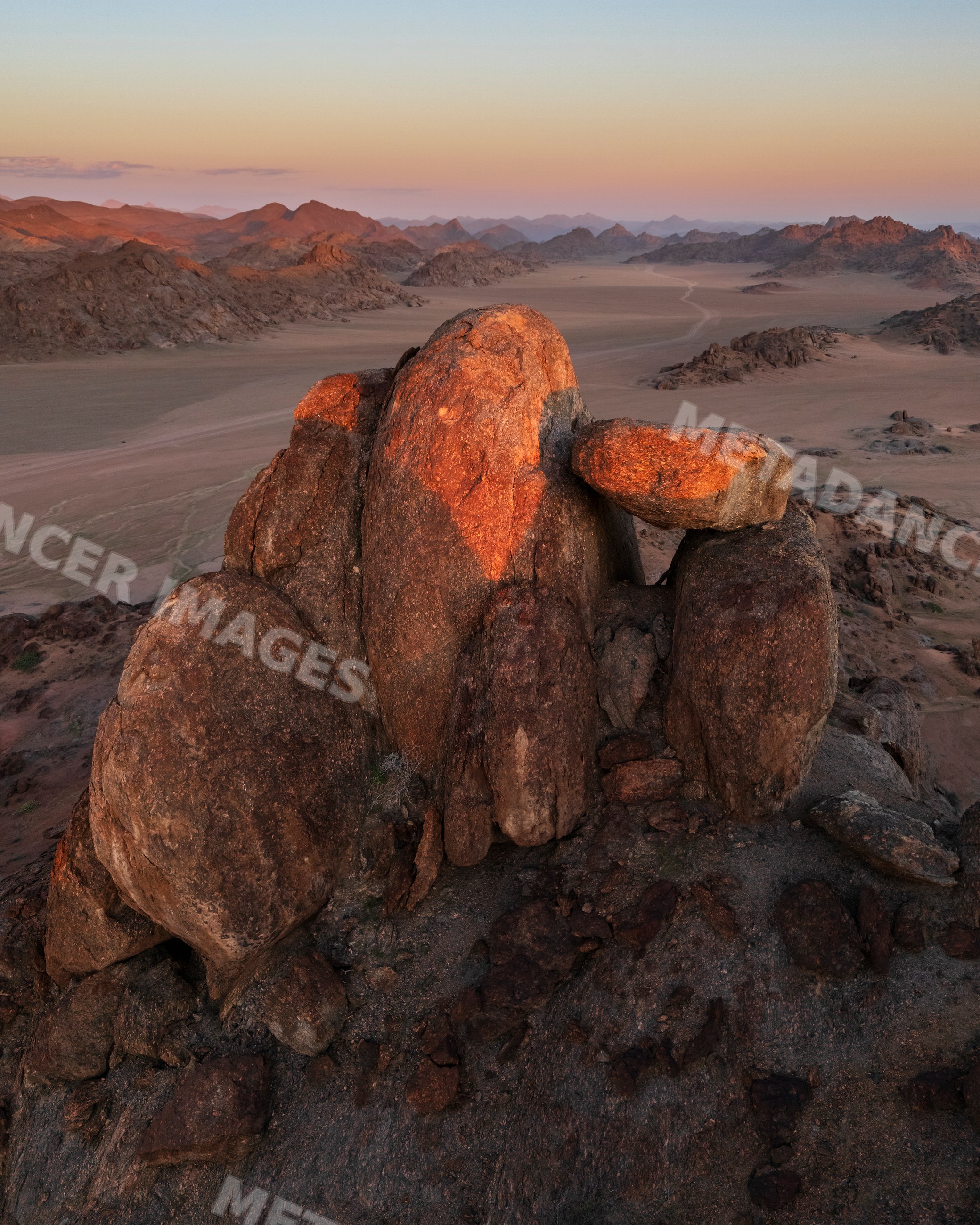 Balanced Rock formation in Namibia's stone valley desert at sunset