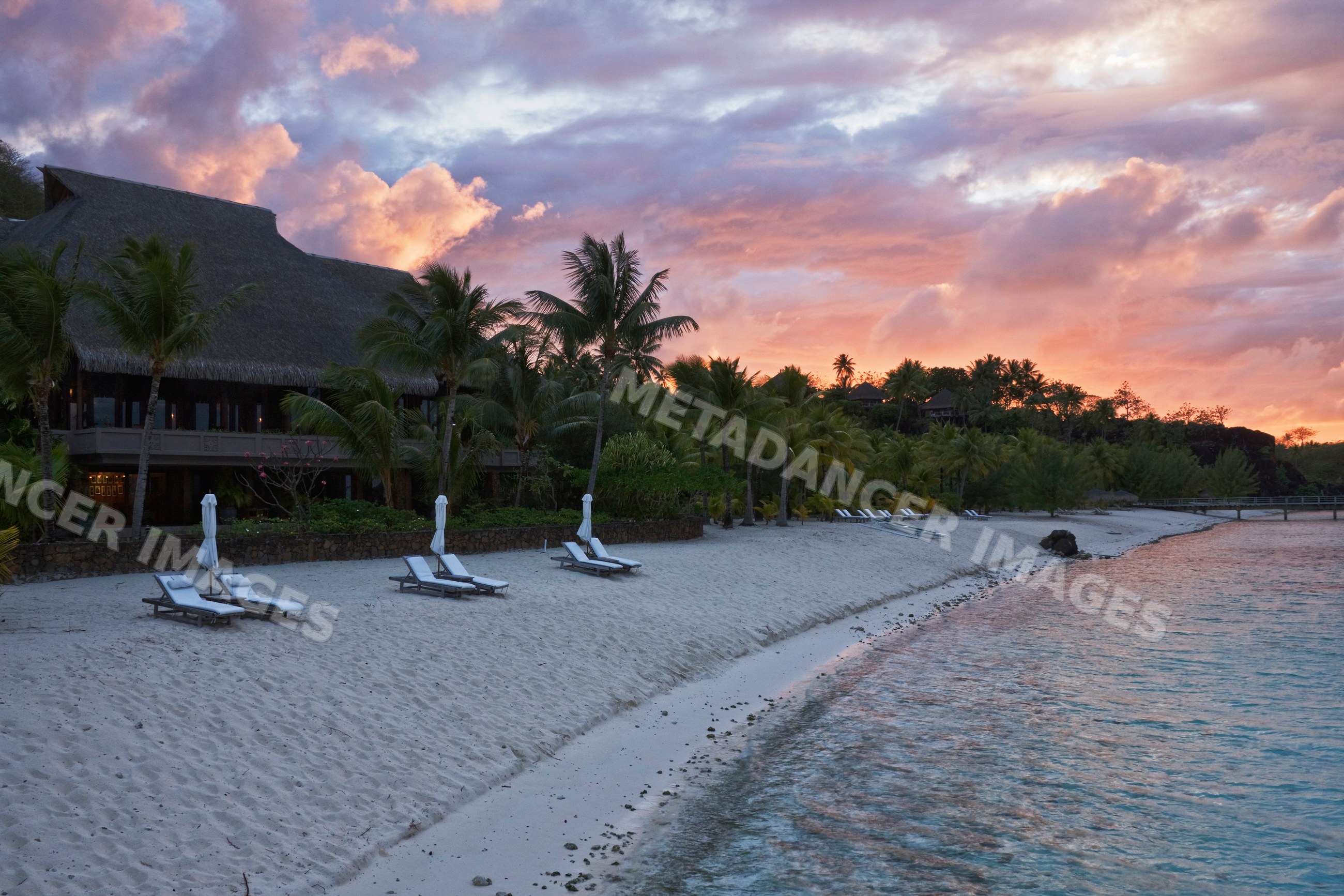 Sunrise sky with clouds over a thatched roof bora nui resort