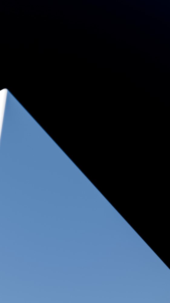 Blue sky with black shadow along building roof edge