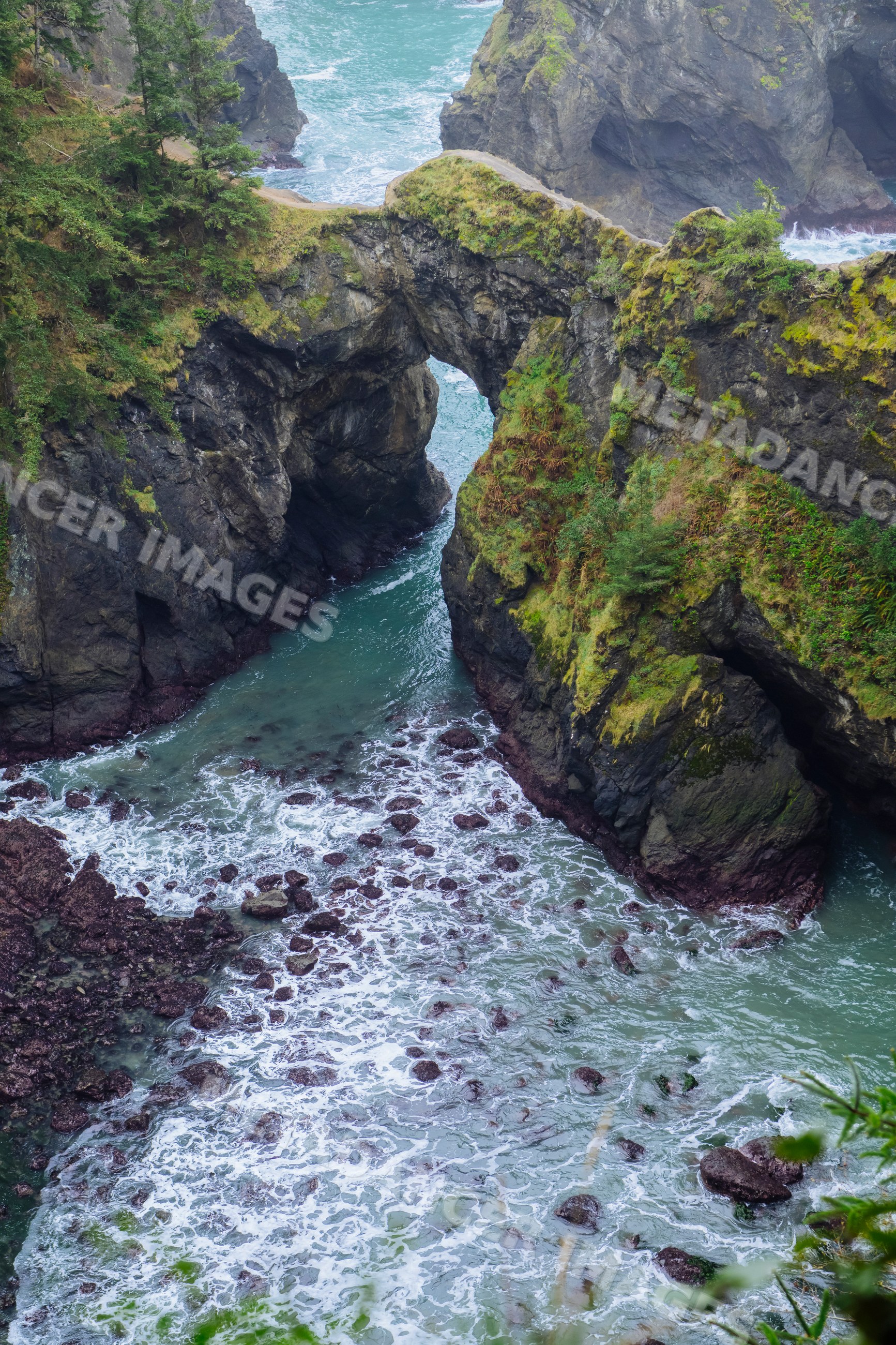 Natural rock arch over ocean waves Oregon