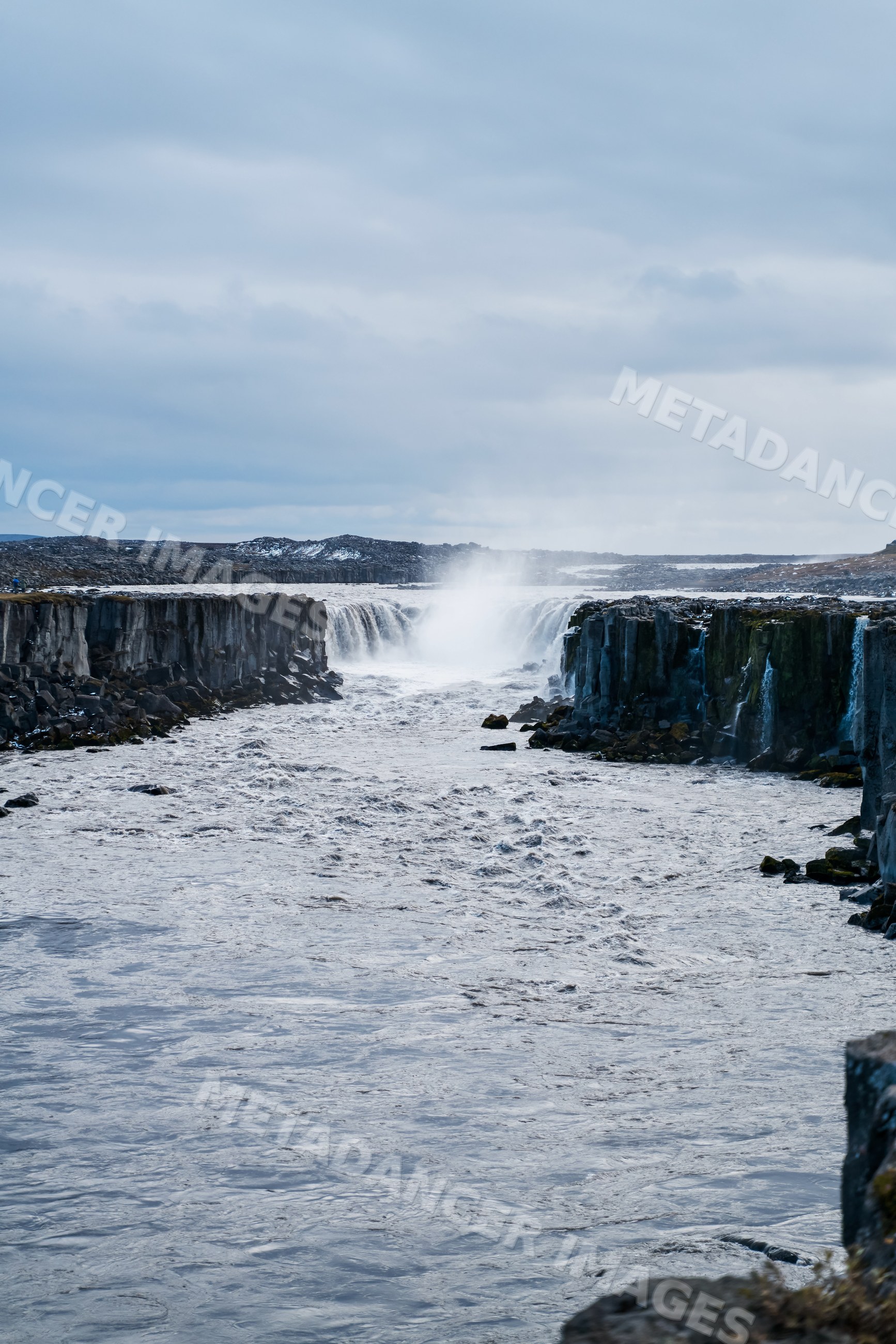 Waterfall cascading through basalt cliffs in Iceland natural landscape