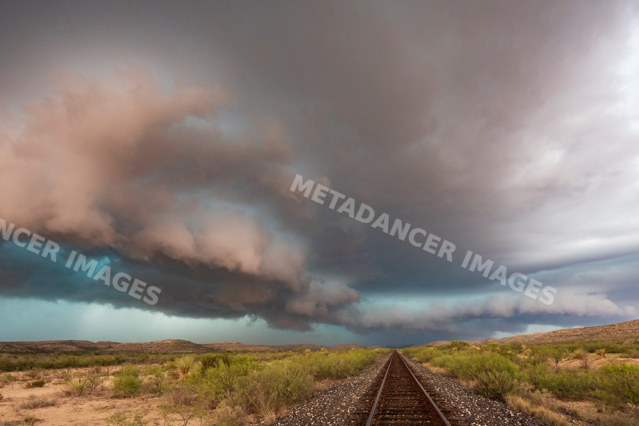 Railway tracks under storm clouds in sanderson, texas Great Plains