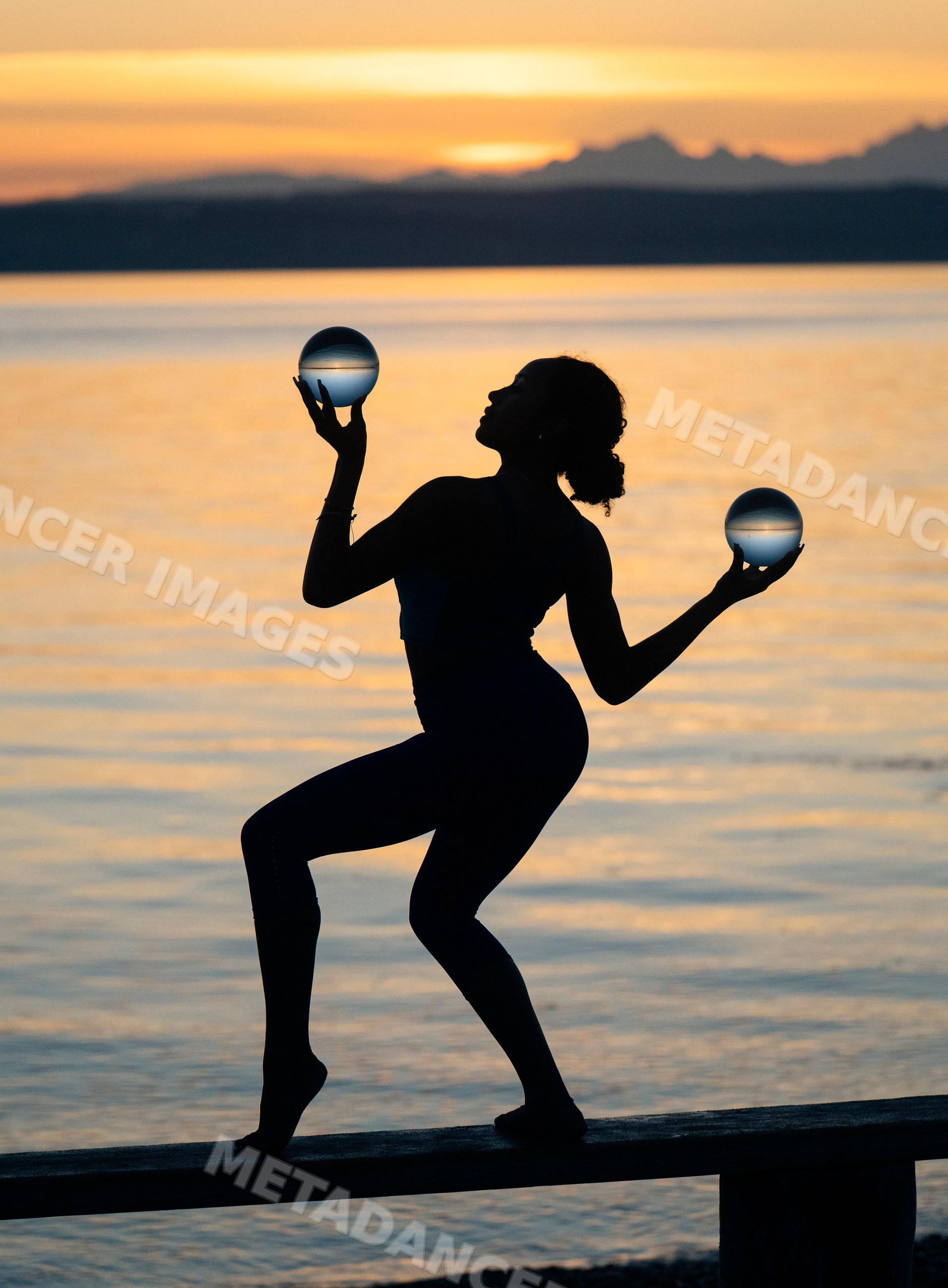 Hispanic woman balancing glass spheres