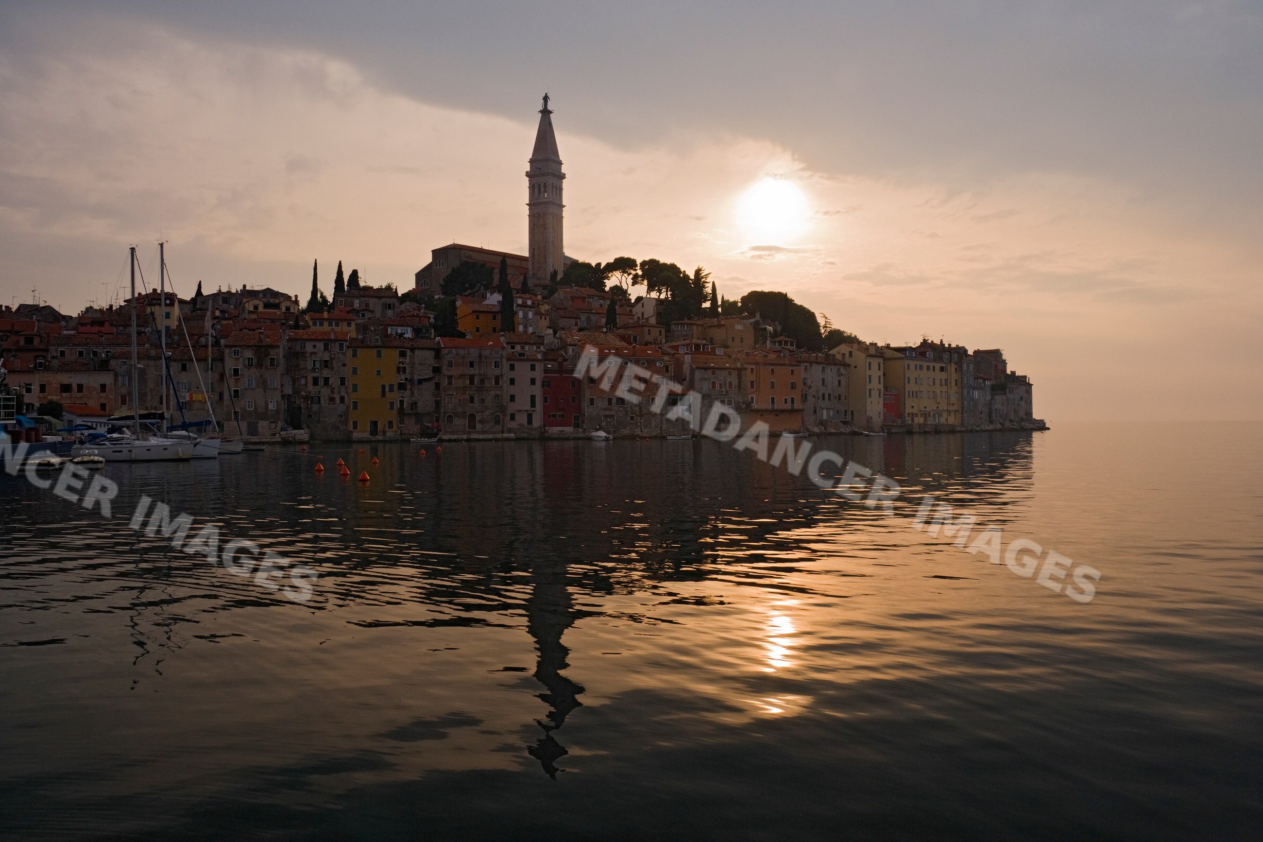 Town of rovinj reflecting on calm water
