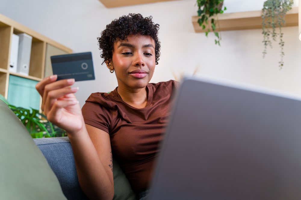 African American woman using credit card for online shopping