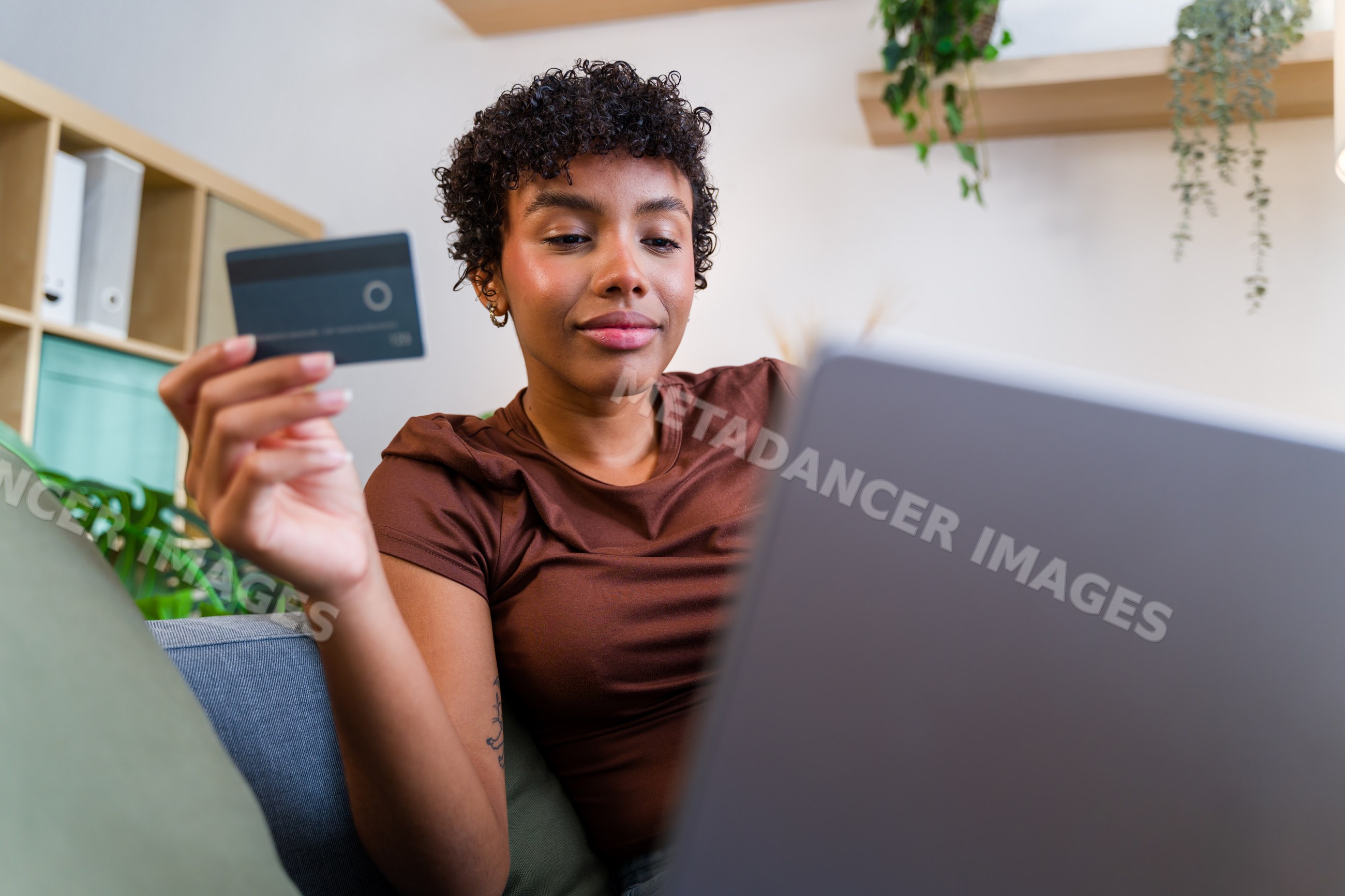 African American woman using credit card for online shopping