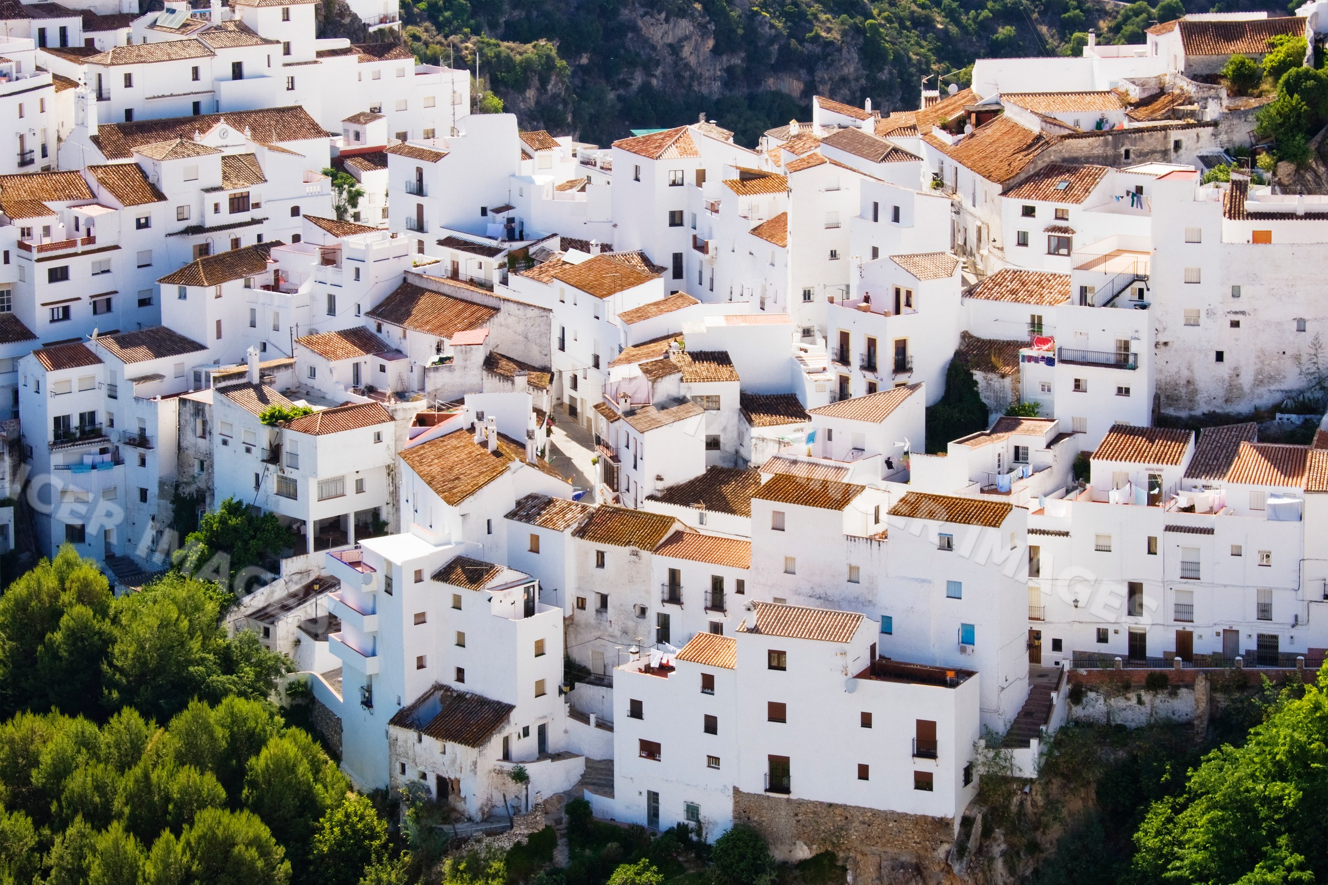 White houses on hillside, Spain with terracotta rooftops