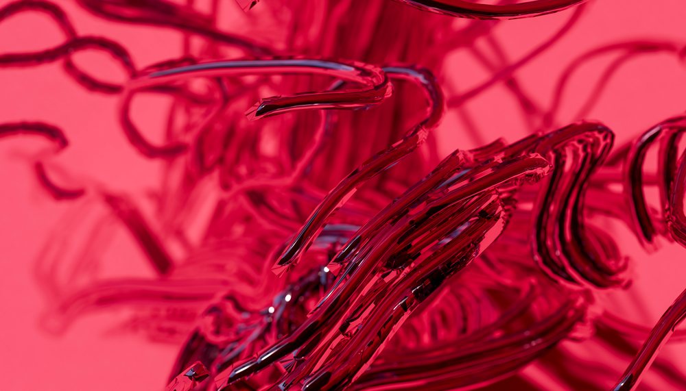 Close-up of abstract curved red glass tubes with reflective surfaces