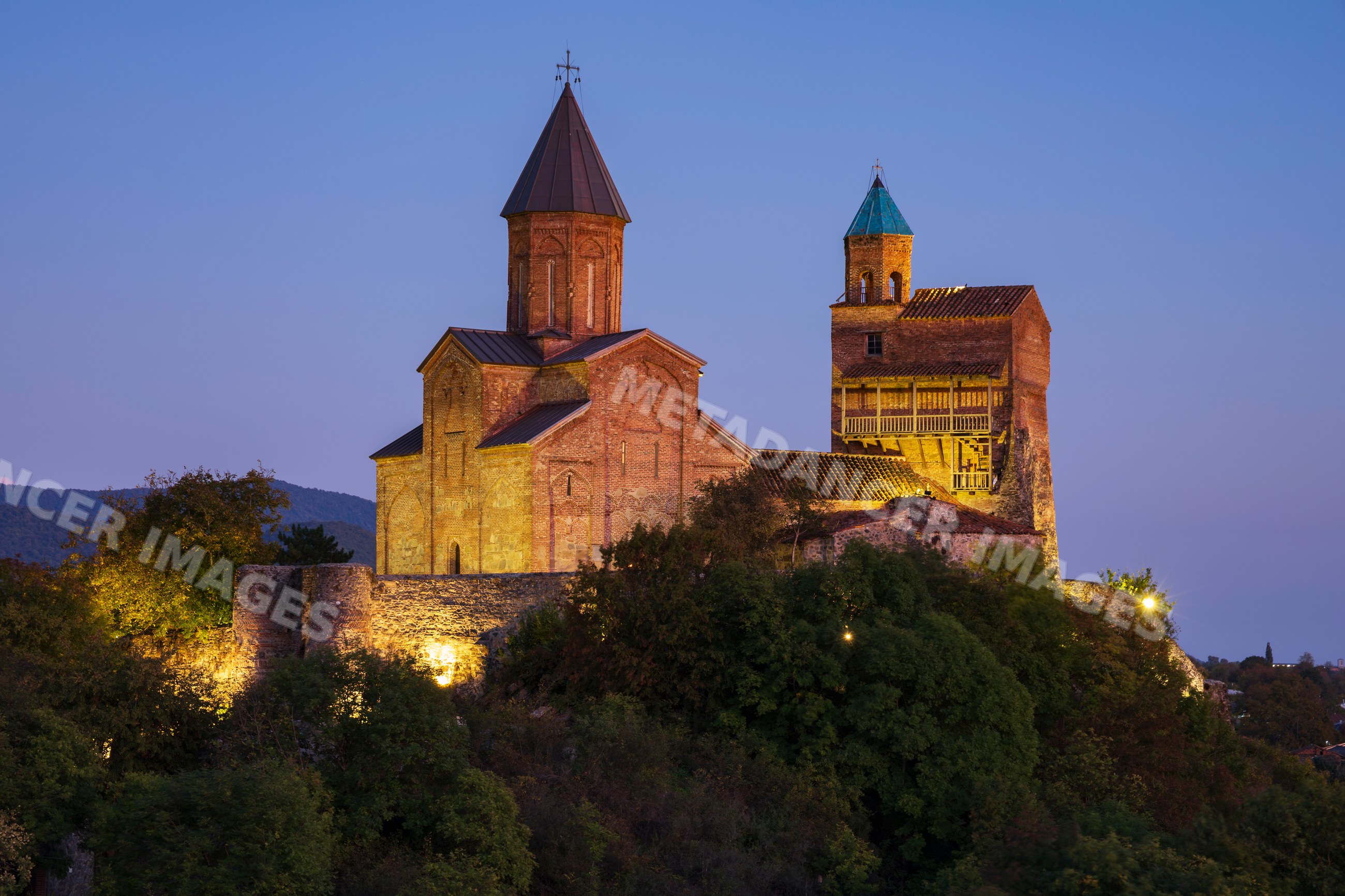 Gremi monastery with illuminated church and tower at Dusk in sighnaghi