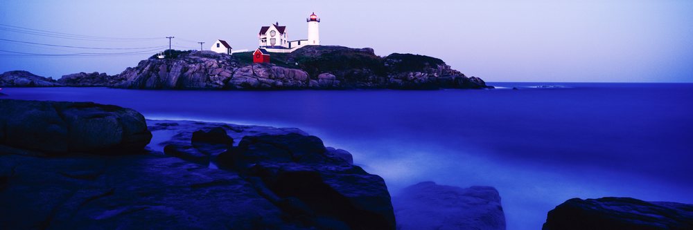 Nubble lighthouse on rocky coast at cape neddick