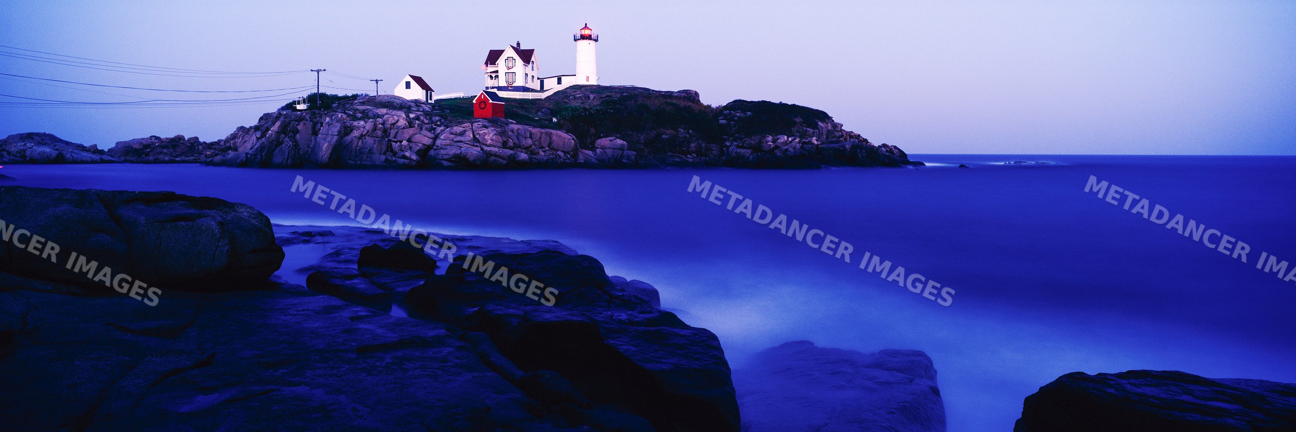 Nubble lighthouse on rocky coast at cape neddick