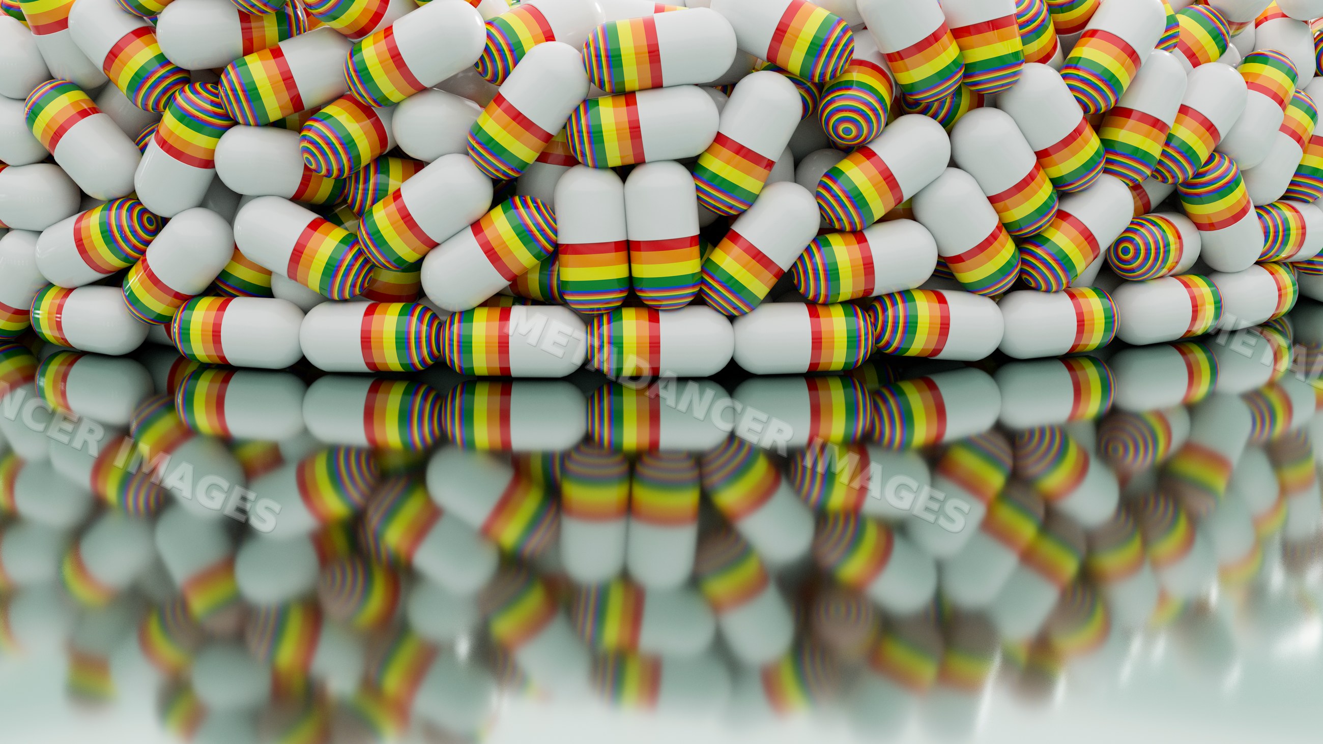 Capsules with rainbow stripes stacked reflecting on glossy surface