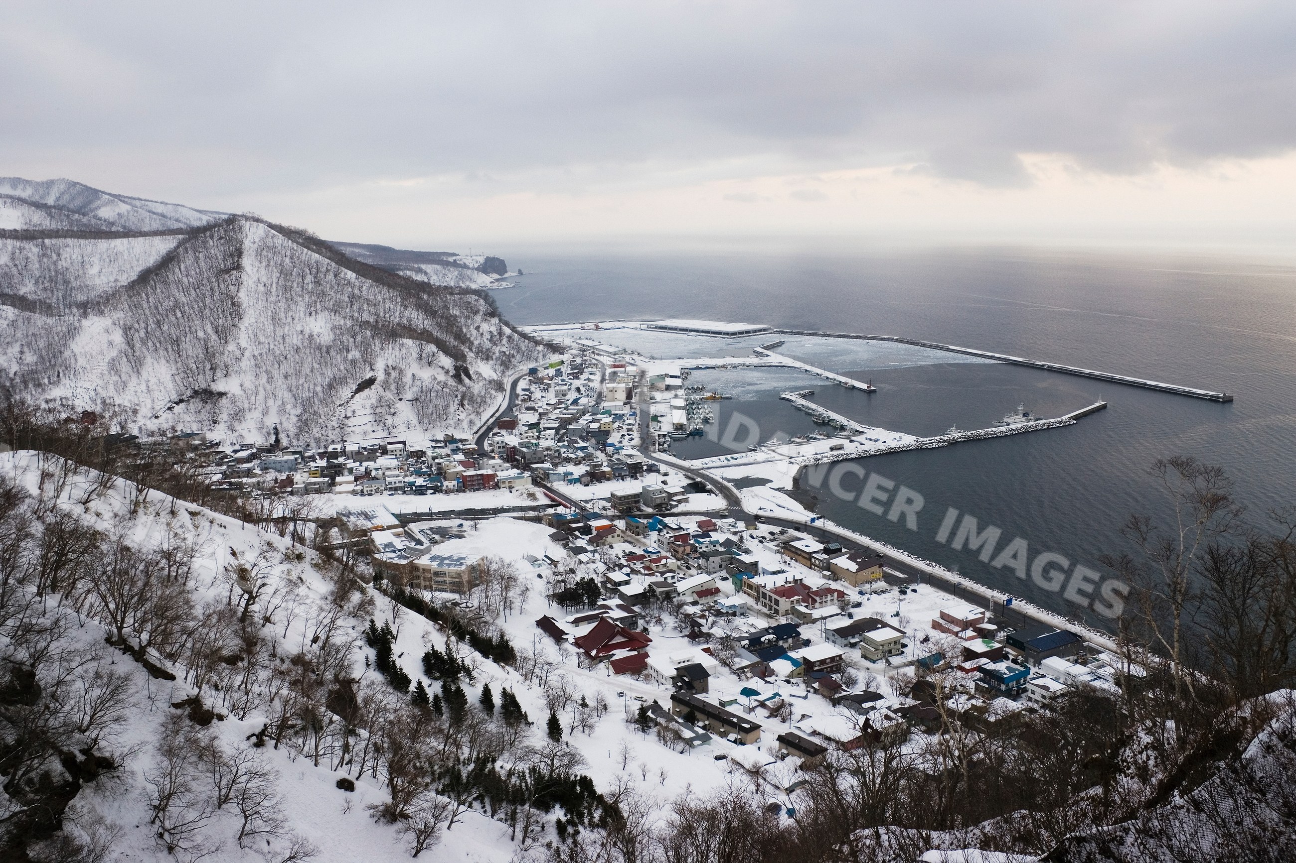 Rausu town and harbor in snowy shiretoko peninsula winter landscape