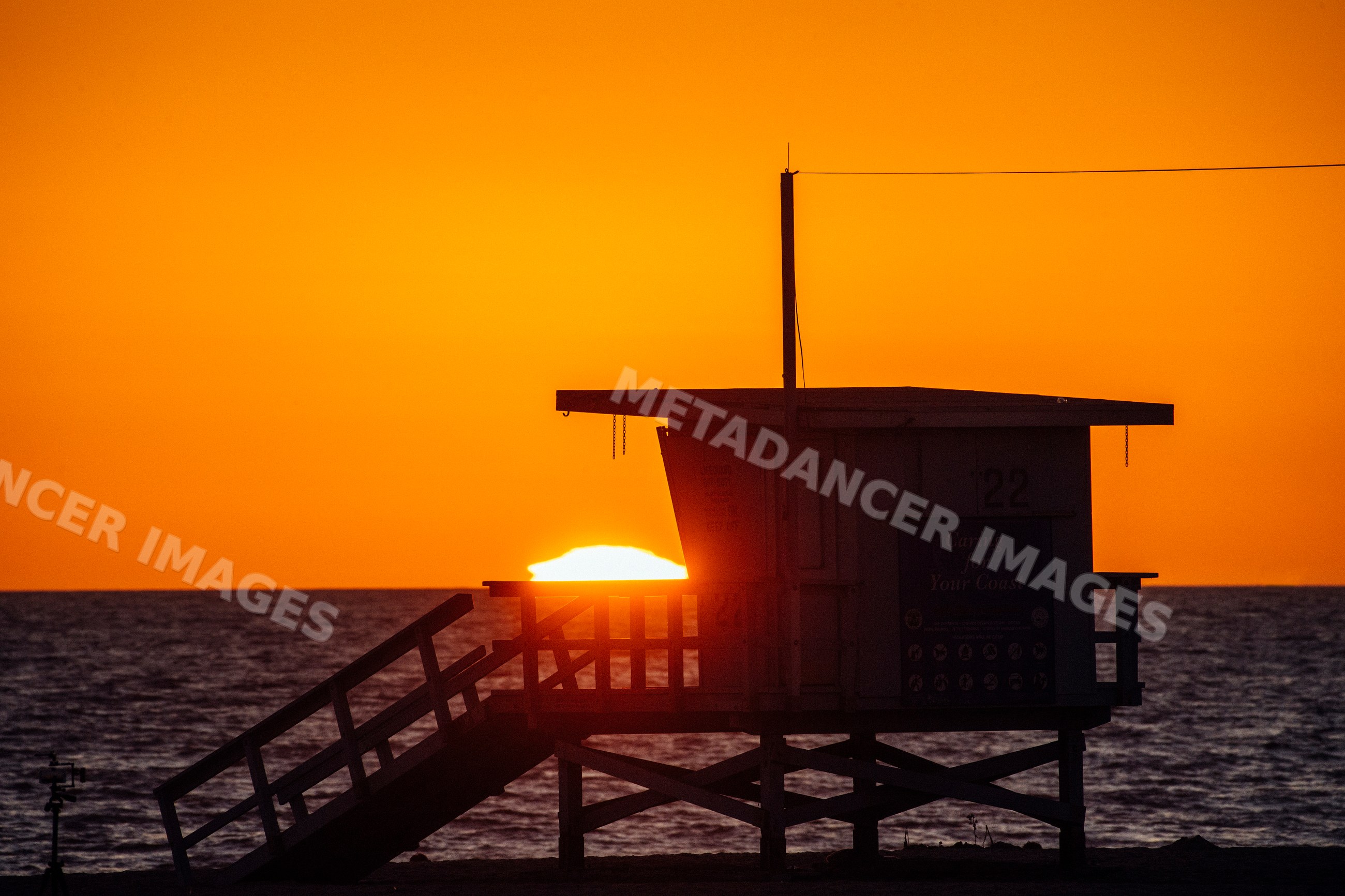 Sunset behind lifeguard tower on Santa Monica beach