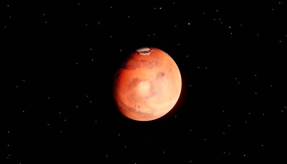 Red planet with polar ice cap floating in outer space