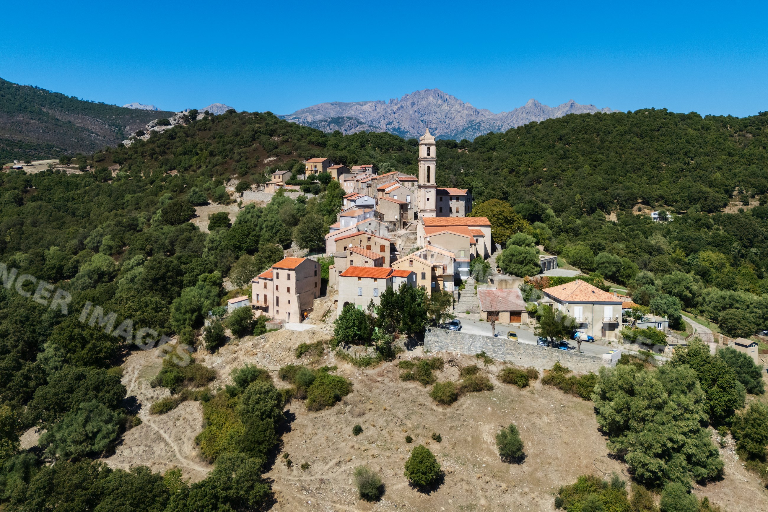 Soveria hill town in corsica france with church tower and mountains