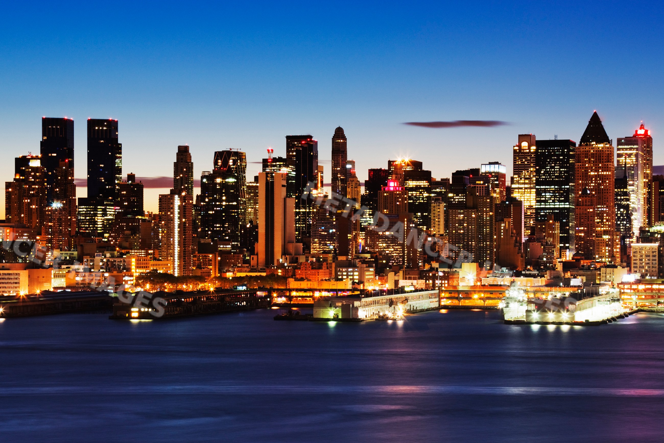 Skyline of midtown manhattan illuminated at dusk city
