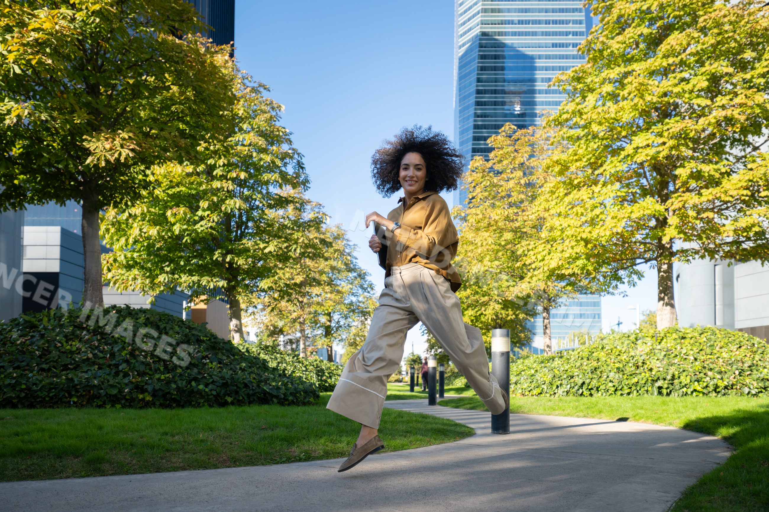 Woman jumping with skyscrapers in Madrid, Spain