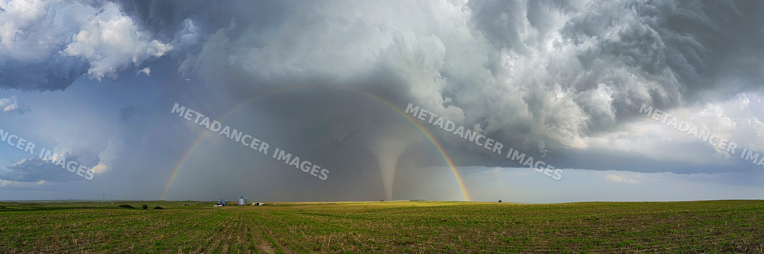 Tornado with Double Rainbow in storm clouds over nebraska field