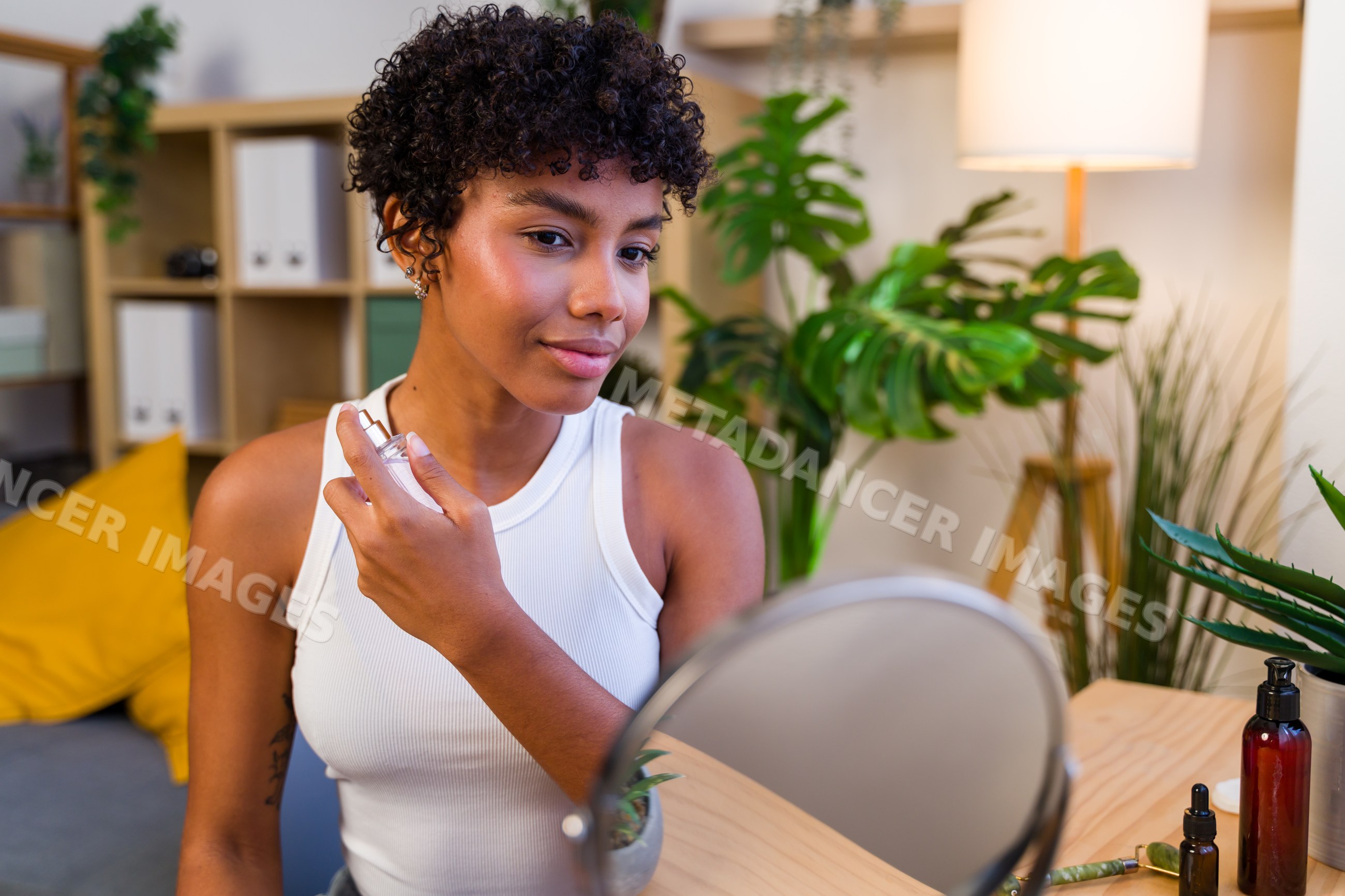 African American woman applying perfume