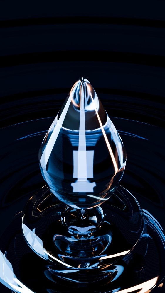 Close-up of water droplet with ripples and reflections