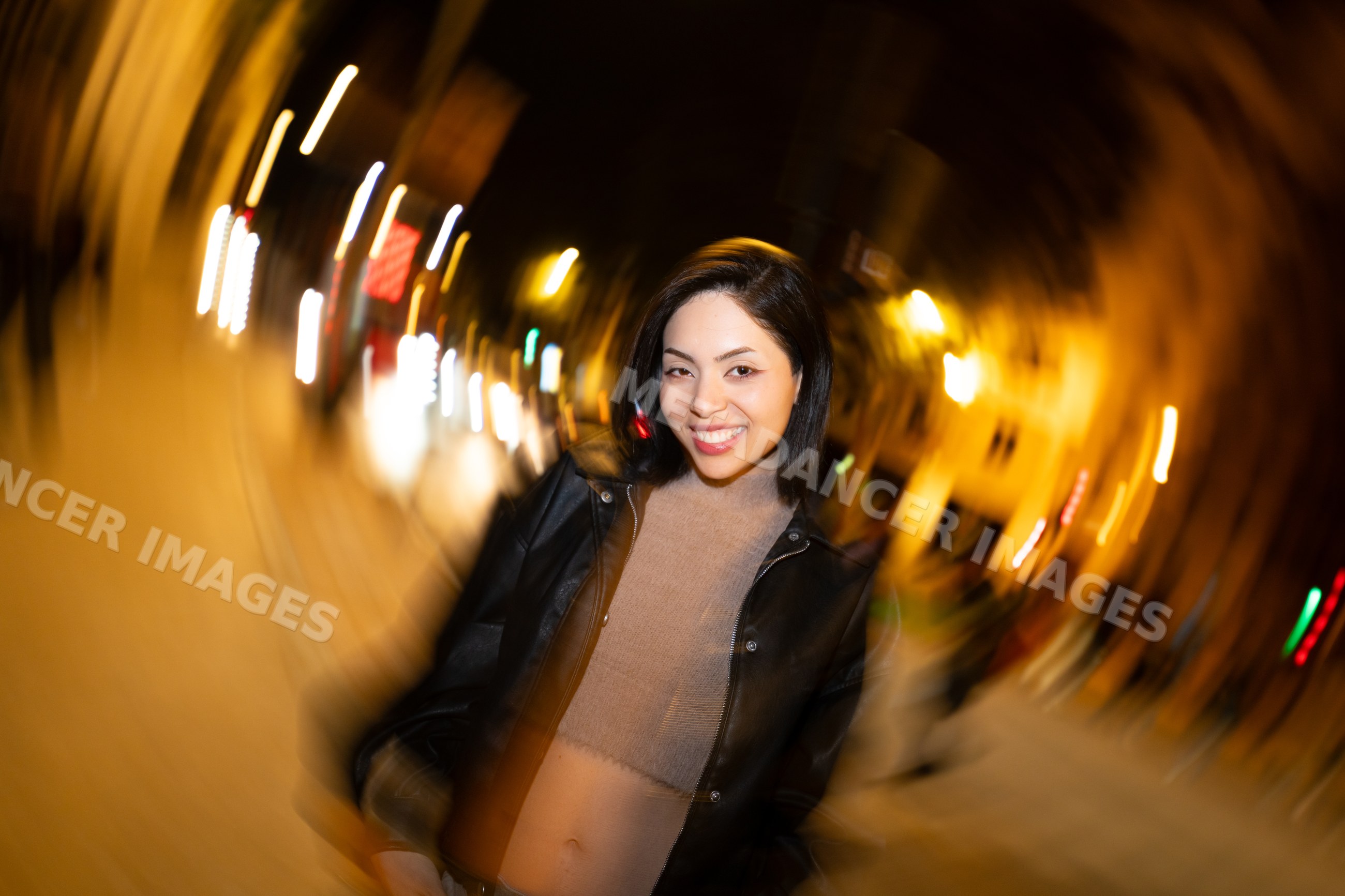 Hispanic woman smiling on city street