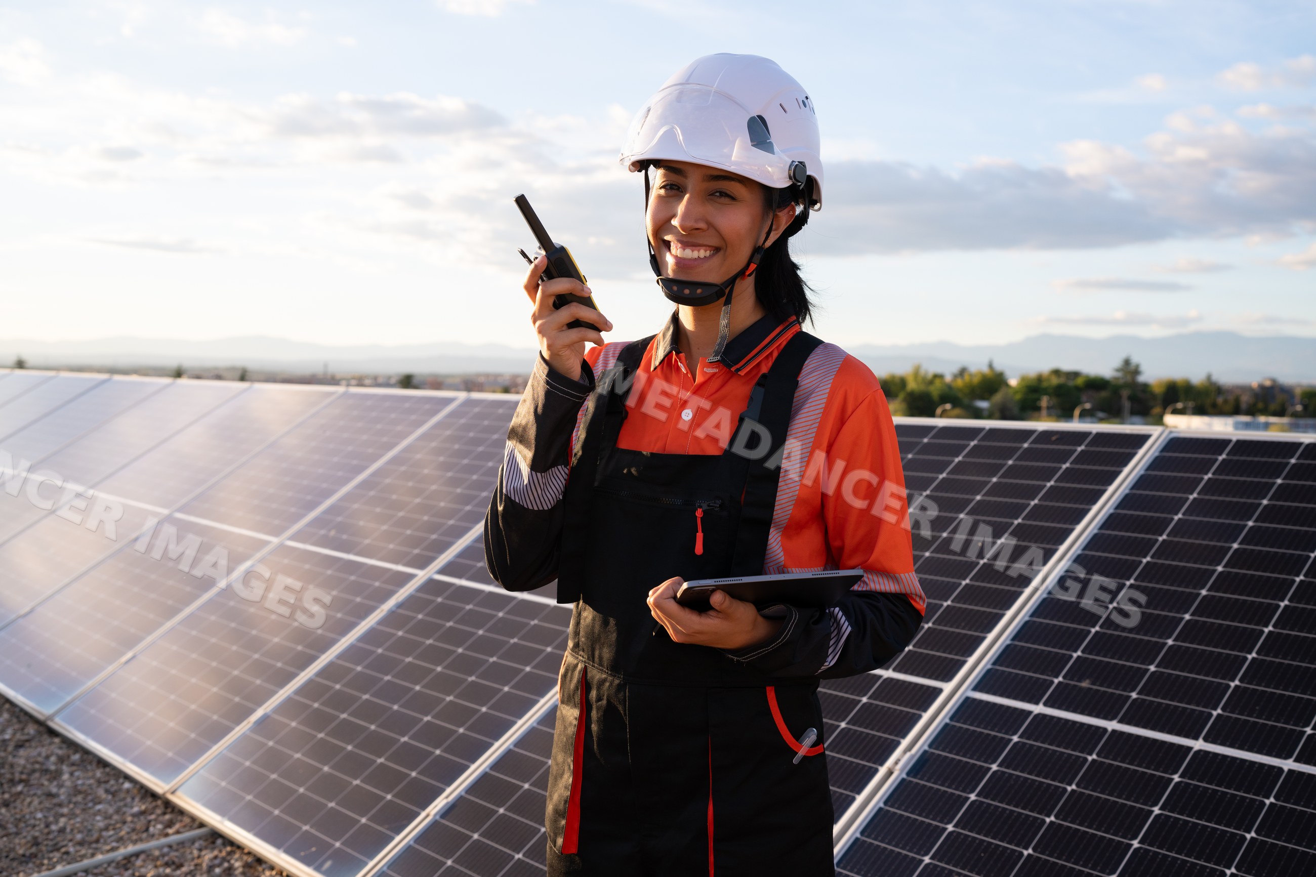Solar energy technician inspecting photovoltaic panels outdoors