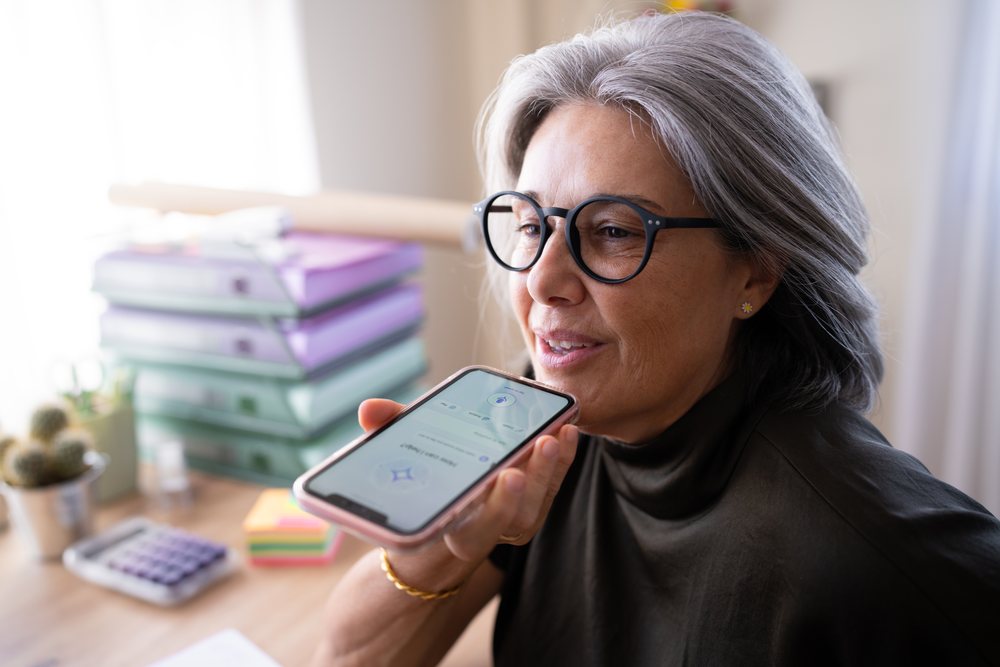 Middle-aged white woman using smartphone in office