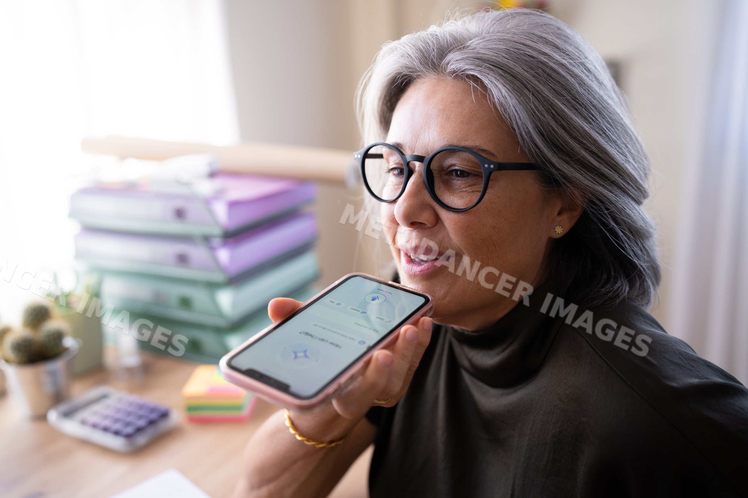 Middle-aged white woman using smartphone in office