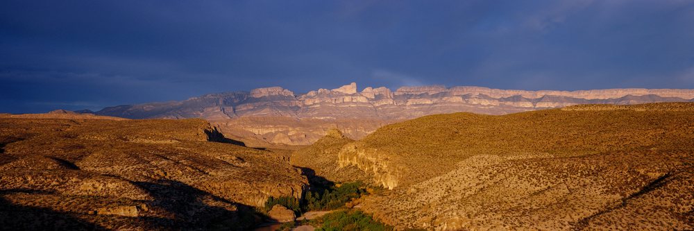 Scenic mountain ridge and desert canyon at sunset