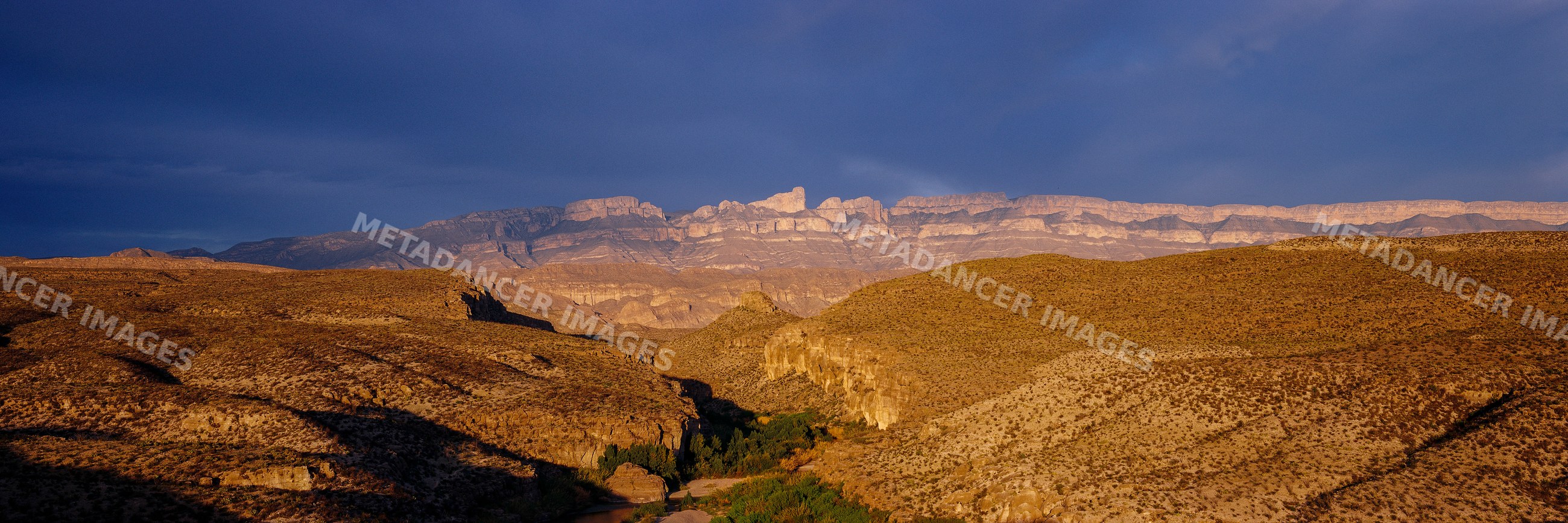 Scenic mountain ridge and desert canyon at sunset