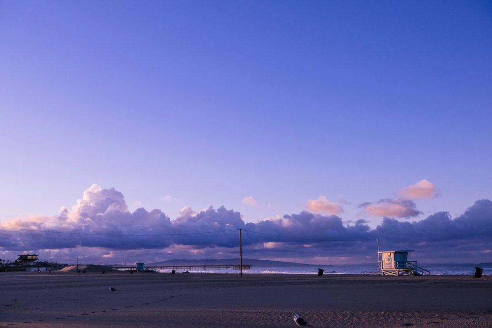 Venice Beach shoreline with lifeguard towers at sunset in california