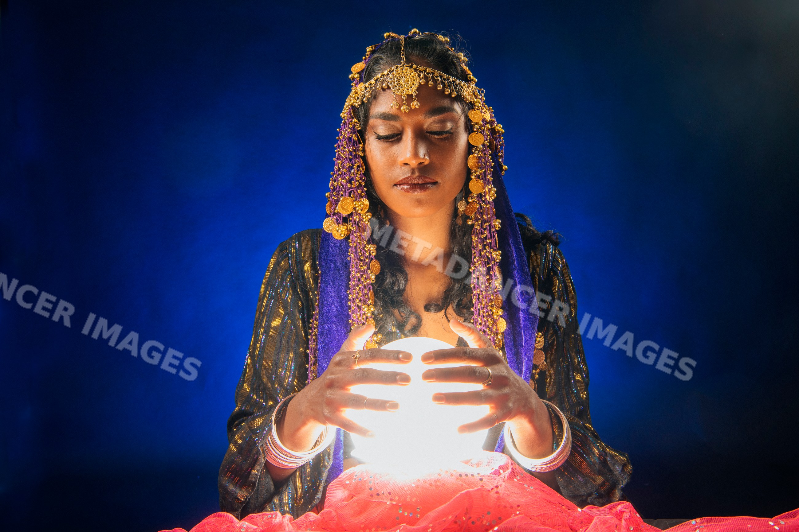 A fortune teller holding a glowing crystal ball in a mystical setting