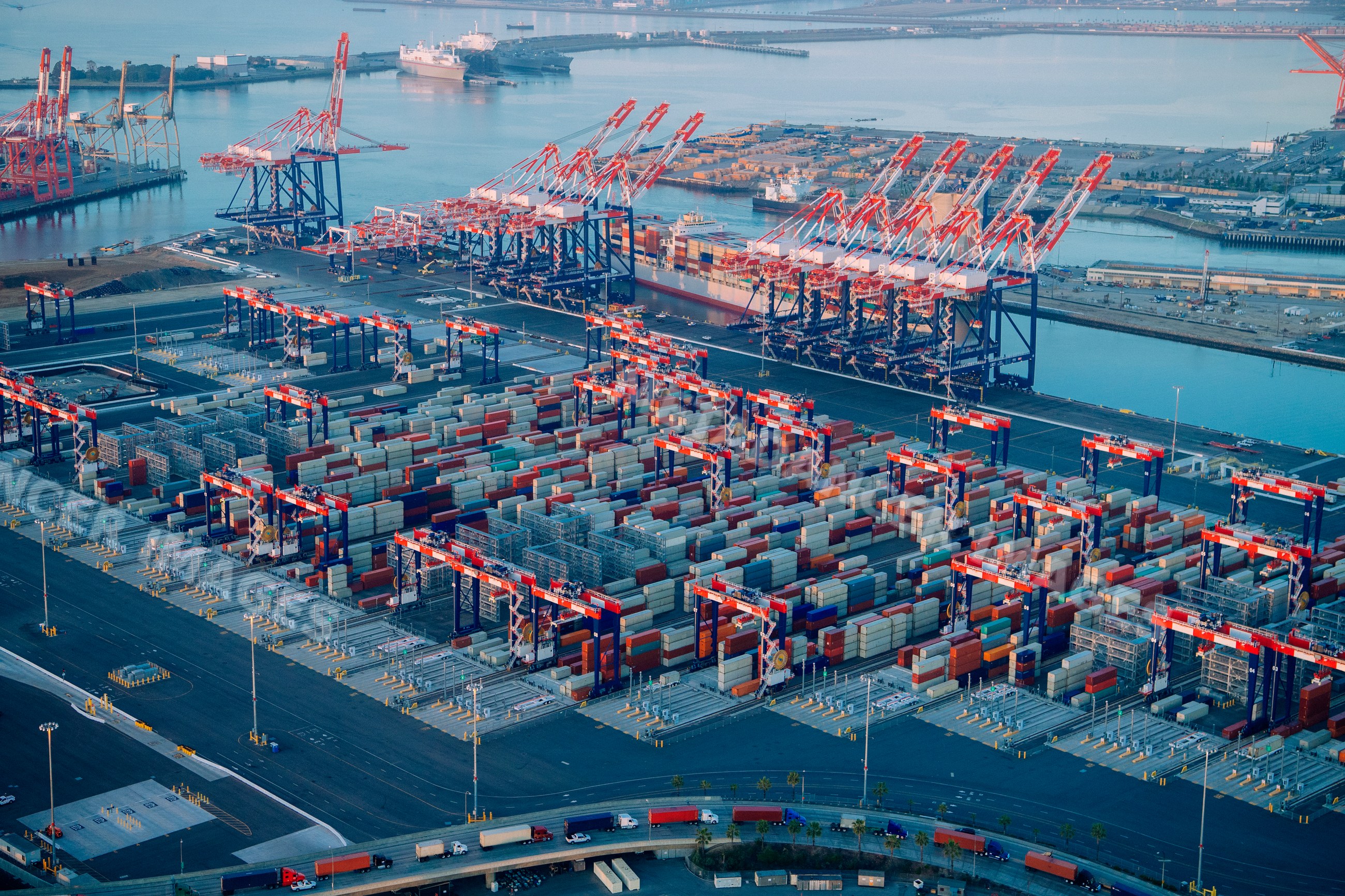 Container terminal with cranes and stacked shipping containers