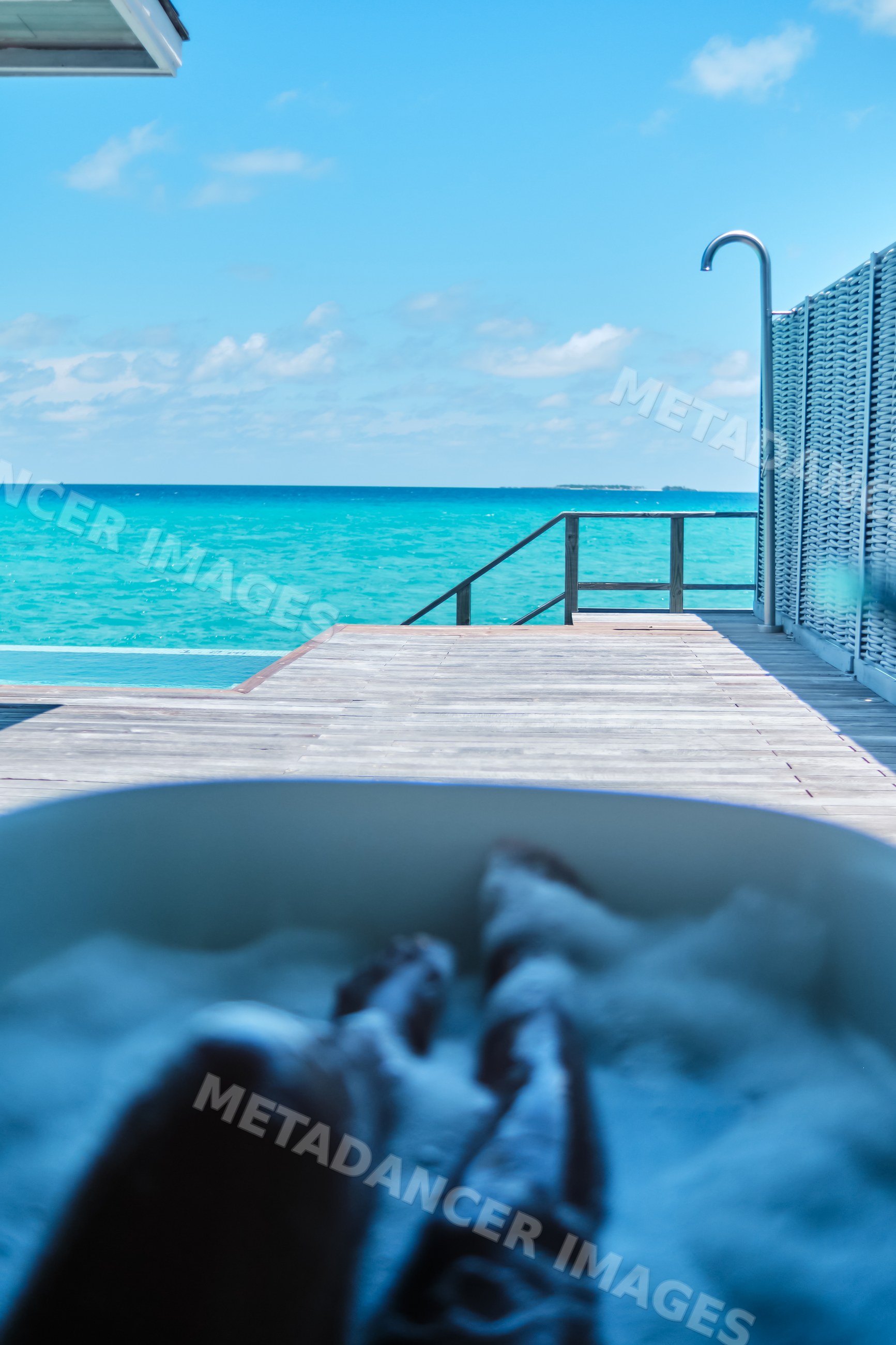 A relaxing soak in an outdoor bathtub with an ocean view