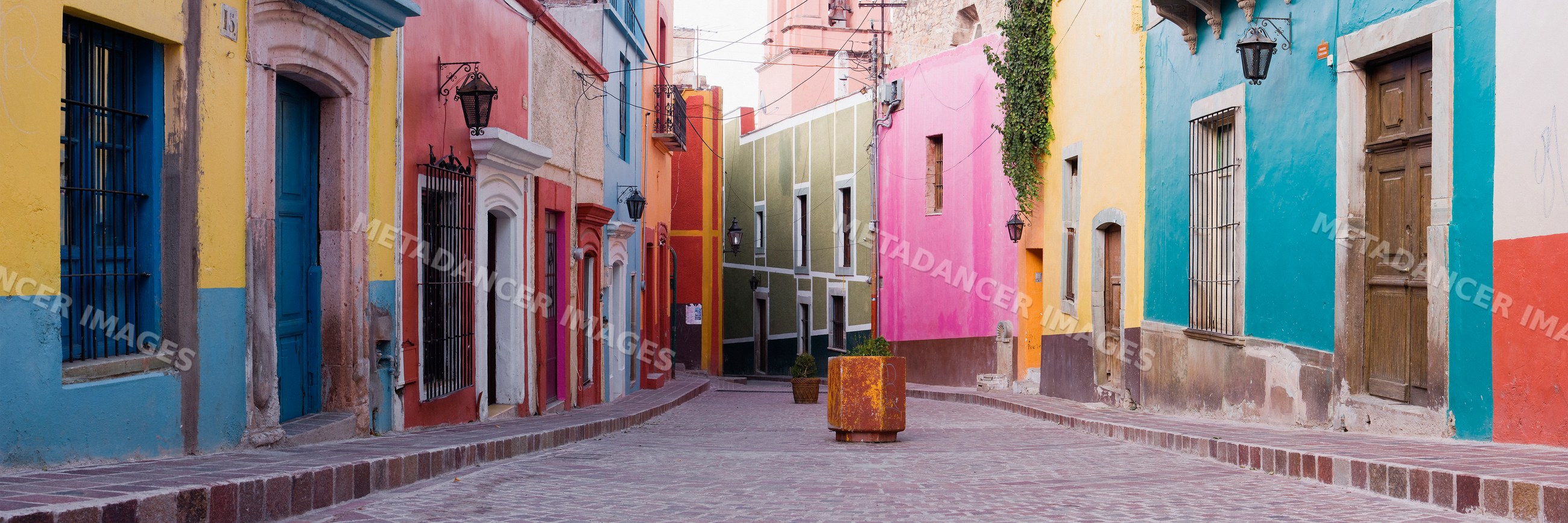 Colorful buildings lining a cobblestone street, mexico