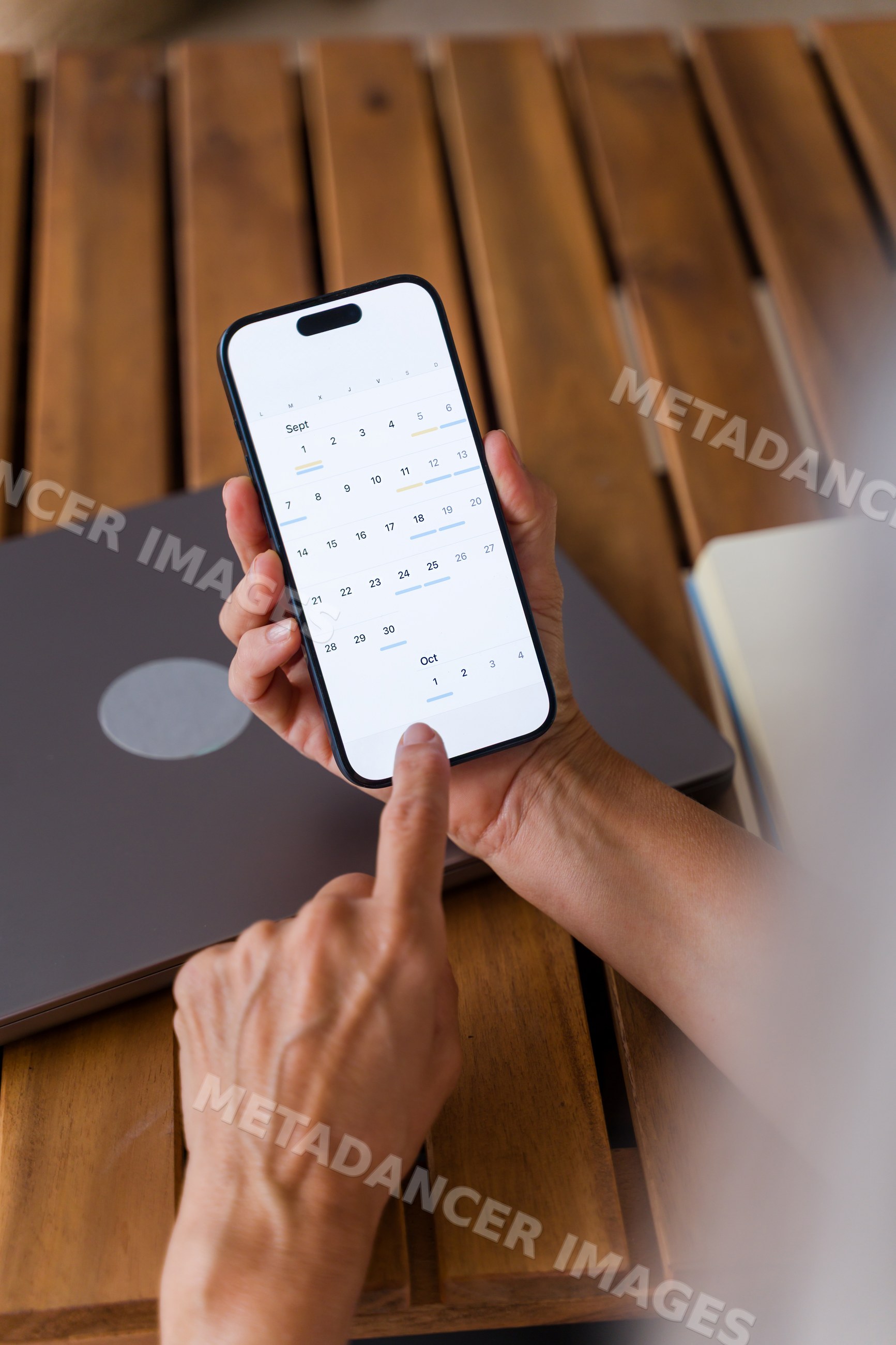 Smartphone displaying digital calendar app with scheduled events