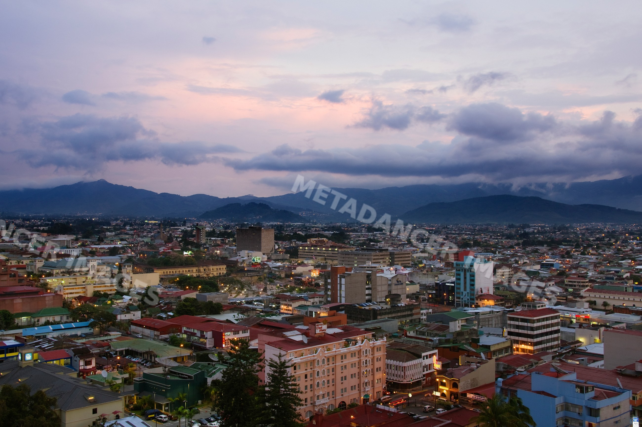 Cityscape of san jose, costa rica at sunset with mountain backdrop